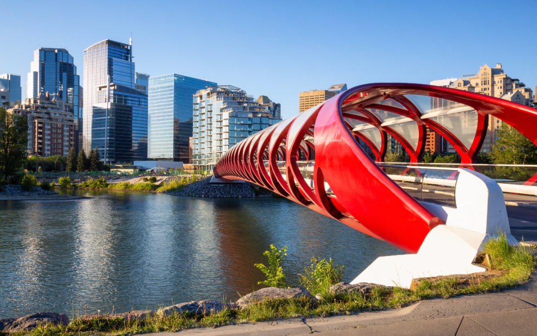Peace Bridge across Bow River in Calgary on a sunny day with a big blue sky in the background.