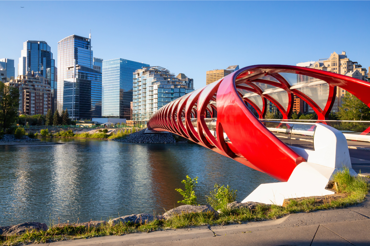 Peace Bridge across Bow River in Calgary on a sunny day with a big blue sky in the background.
