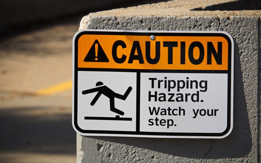 Sign calling out slip and fall risk at business site