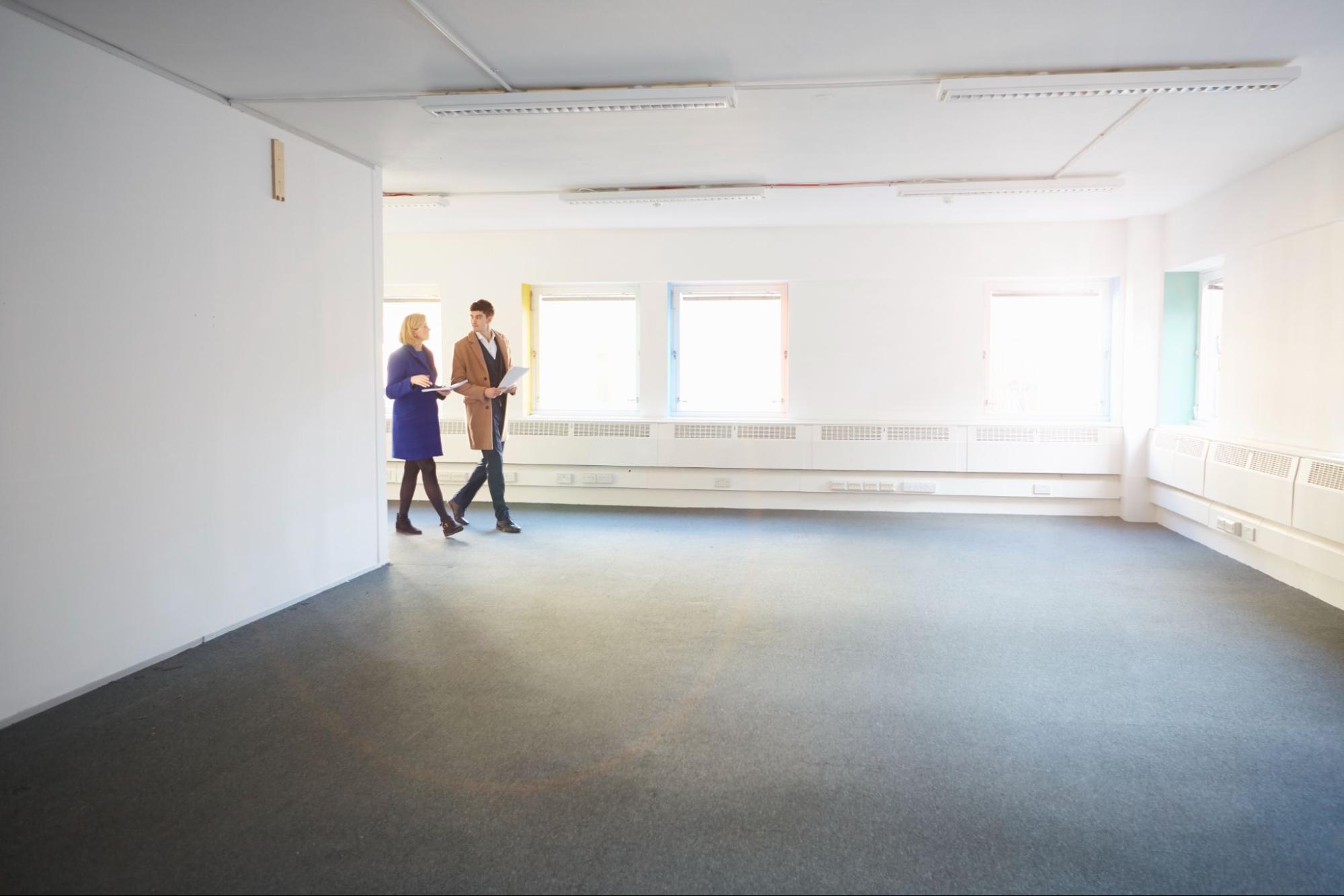 image3 Property managers walking through vacant area of commercial property